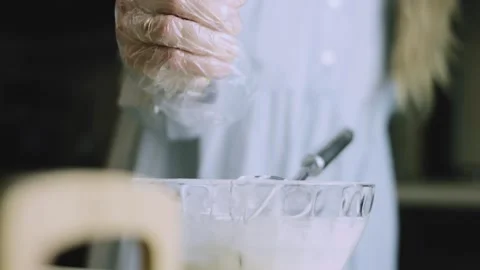 4K Baker Stirring a Clear Bowl of Gingerbread Ingredients Stock Footage 342113219