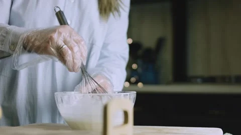 4K Baker Stirring a Thick Cookie Mixture at the Kitchen Table Stock Footage 342113180