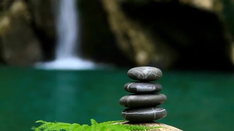 4K Balanced Stack Of Rocks In Front Of Blurred Waterfall Background 스톡 동영상 334453306