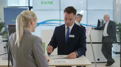 4K Bank with friendly adviser talking to customer, as seen from customer's pov Stock Footage