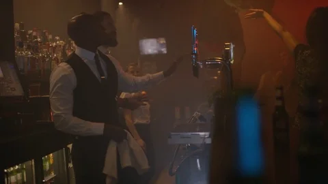 4K Bar Staff &amp; Customers Dancing &amp; Enjoying The Atmosphere In Lively Nightclub Stock Footage 75792016