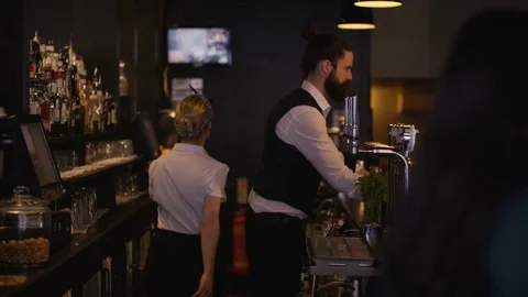 4K Bar Staff Serving Drinks &amp; Female Friends Chatting In City Bar. Stock Footage 75772864