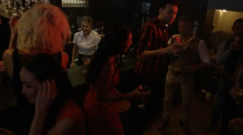 4K Bar staff working &amp; young party crowd dancing in nightclub.  Stock Footage 64615331