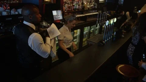 4K Bar Staff Working &amp; Young Party Crowd Dancing In Nightclub Video stock 75652323