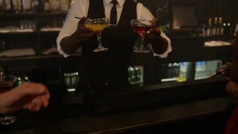 4K Barman Serving Drinks To Happy Young Party Crowd In Trendy City Bar Video stock 75619634
