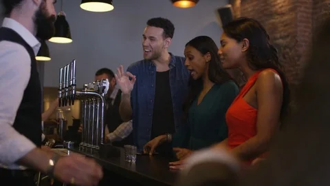 4K Bartender Pouring Shots For Group Of Friends &amp; Taking Photo With Camera Phone Stock Footage 75803518