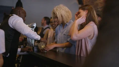 4K Bartender Pouring Shots For Group Of Friends Partying In City Bar Stock Footage 75804577