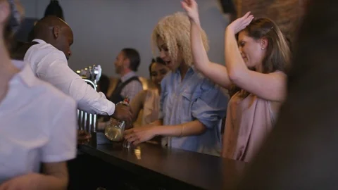 4K Bartender Pouring Shots For Group Of Friends Partying In City Bar Stock Footage 75804802