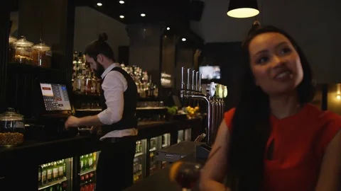4K Bartender Taking Credit Card Payment For Drinks From A Customer 動画素材 75798856