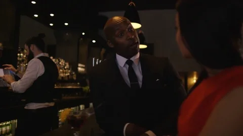 4K Bartender Taking Credit Card Payment For Drinks From A Customer Stock Footage 75799396