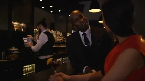 4K Bartender Taking Credit Card Payment For Drinks From A Customer Stock Footage 75799599