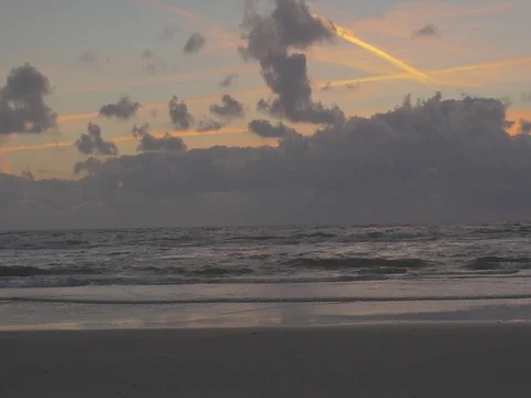 4k beach and ocean waves at dusk with orange clouds (1) Video stock 75079634