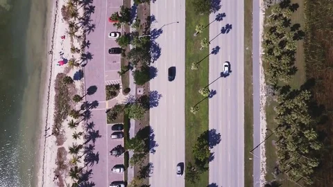 4k beach &amp; road flyover, moving water, moving traffic, sunny 스톡 동영상 82801577
