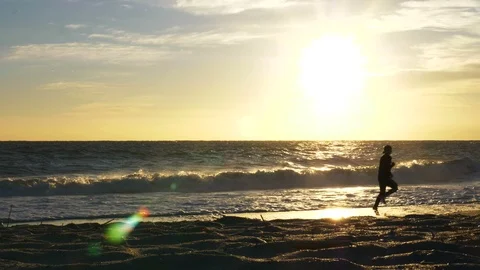 4K Beach Runner Running in Water During Morning Sunrise in Florida Video stock 104411740
