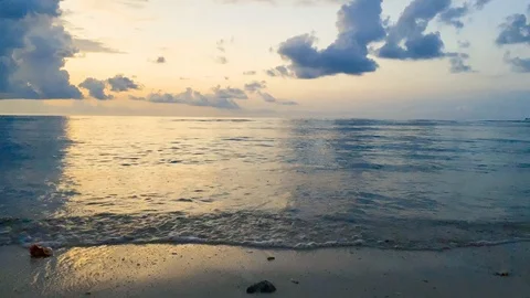 4K beach shore gili island peaceful sunset clouds reflection water Stock Footage 107847341