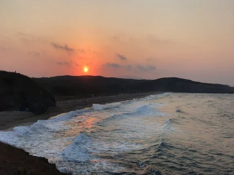 4K. Beach at sunset with wave foam. Stock Footage 80546413
