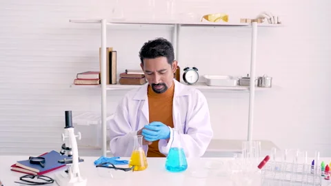 4K,The bearded man is a lab coat-wearing science teacher in gloves, and test Stock Footage 212670574