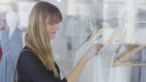 4K Beautiful female customers shopping in fashionable boutique clothing store Stock Footage
