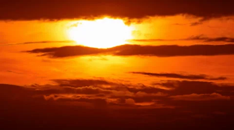 4K. Beautiful scenic sunset sun across fiery red sky background. Timelapse Stock Footage