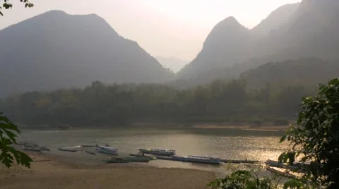 4K Beautiful sunset landscape view, river, boats, mountains, Laos. Long shot Stock Footage 65709538