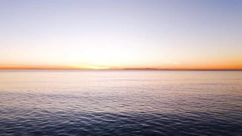 4K Beautiful Sunset Over Vast Ocean or Large Sea Body of Water Video stock 332157672
