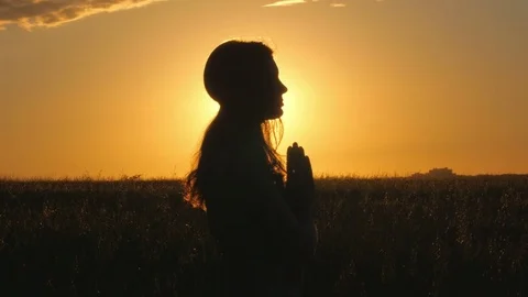 4k of Beautiful young woman silhouette doing yoga over orange sunrise Stock Footage