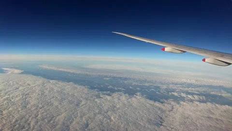 4K, Beauty clouds with light sun from above, as seen through airplane window-Dan Stock Footage 134280049