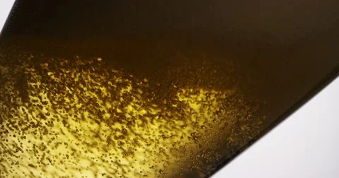 4K Beer being poured into a tilted glass, in slow motion Stock Footage 65816171