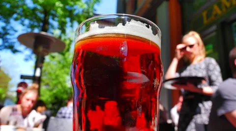 4K Beer Pint, Bubbles in Head Foam, Cold Glass in Warm Sun Stock-Footage 62845237