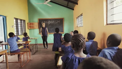 4k behind view of African students / pupils raise hands to answer english langua Stock Footage 199625192