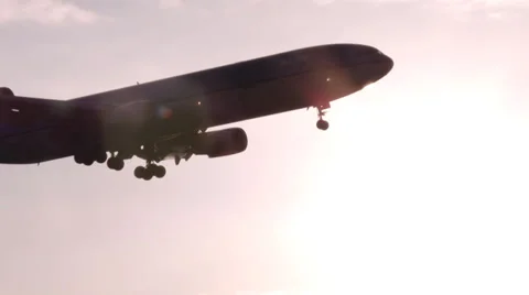 4K Big 3 Engine Airplane crossing sun Stock Footage 39346850