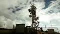 4K big tall communication tower with blue sky and clouds background timelapse HD Footage