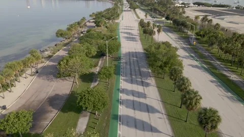 4K Bikers ride on Key Biscayne causeway and Miami skyline 스톡 동영상 244321803