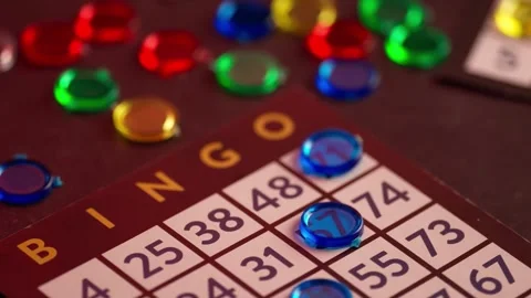 4K Bingo Game in Progress with Players Matching Numbers on Cards Video stock 332157519