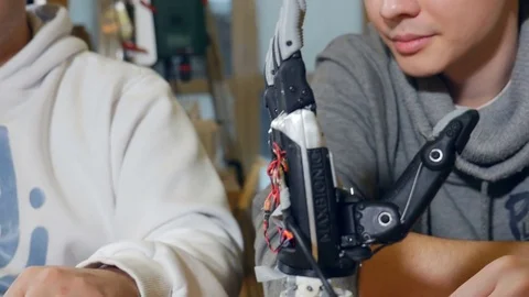 4K. Bionic prosthetic arm. Engineers developing modern robotic device - bionic Stock Footage 72986873