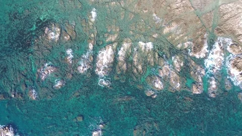 4K bird eye view over crystal-clear ocean rocky coastline with drone 스톡 동영상 257791421