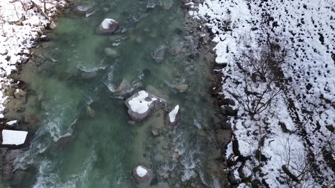 4K Bird Eye View Still Shot above Snowy River during Winter by Drone Stock Footage 257787565