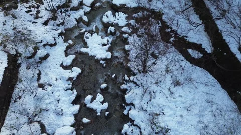4K Bird Eye View Tracking River with Snow during Winter by Drone 스톡 동영상 257787622