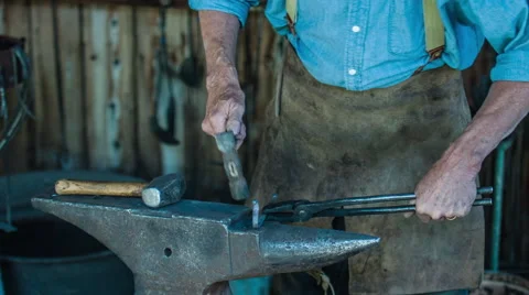 4K Blacksmith uses a hammer on metal work Video stock 45706784