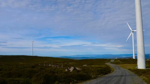 4K, blades of a windmill spinning over a sky full of small white clouds Stock Footage 106929629