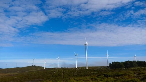 4K, blades of a windmill spinning over a sky full of small white clouds Stock Footage 106929684
