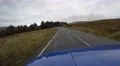 4K blue car is driving fast through english countryside past sheeps and trees 4k or 4k+ Resolution