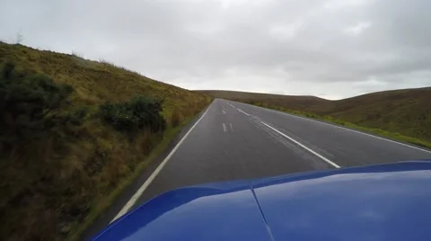 4K blue car driving fast on country road in british countryside, driver pov Stock Footage 47436426