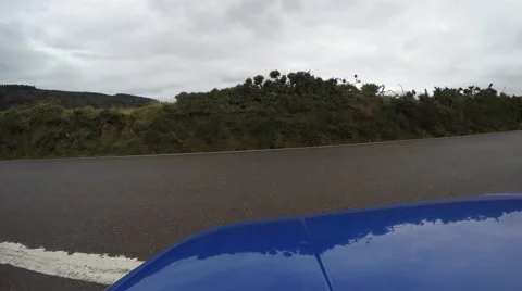 4K blue car is pulling out on a lonely road in the countryside Stock Footage 47435337