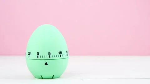 4K blue kitchen egg timer on a pink background. cooking time, soon Easter Stock Footage 256208520