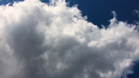 4K Blue sky timelapse or time lapse with huge white clouds moving very fast Stock Footage 122209761