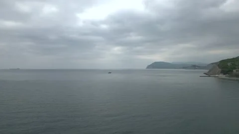 4K. Blue water with small waves turned black in cloudy weather. Video stock 194038773