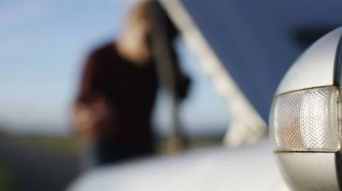 4K Blurred man with a broken down car, focus on hazard lights - version 2 Stock Footage 64962980