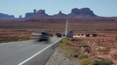 4K blurred motion Time lapse of tourist traffic in sunny Monument Valley Stock Footage 253230887