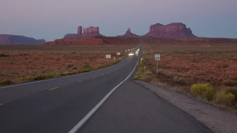4K blurred motion Time lapse of dawn road light streaks in Monument Valley Stock Footage 253231548
